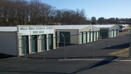 Mills River Storage Center entrance on Boylston Highway, with the facility sign and rows of green-door units